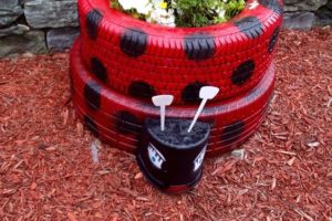 Growing flowers in a ladybird tyre planter!