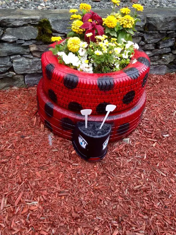 Growing flowers in a ladybird tyre planter!