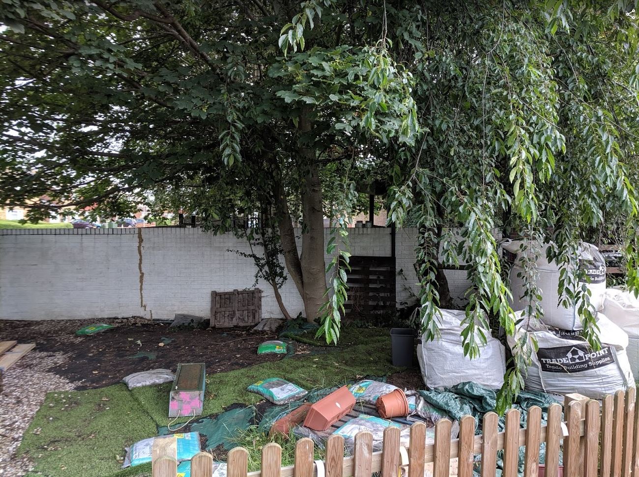 The right side of the Daisychain Family Centre garden - Before our volunteers got to work