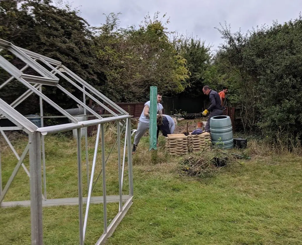 The Allianz UK volunteers started clearing the area for the greenhouse