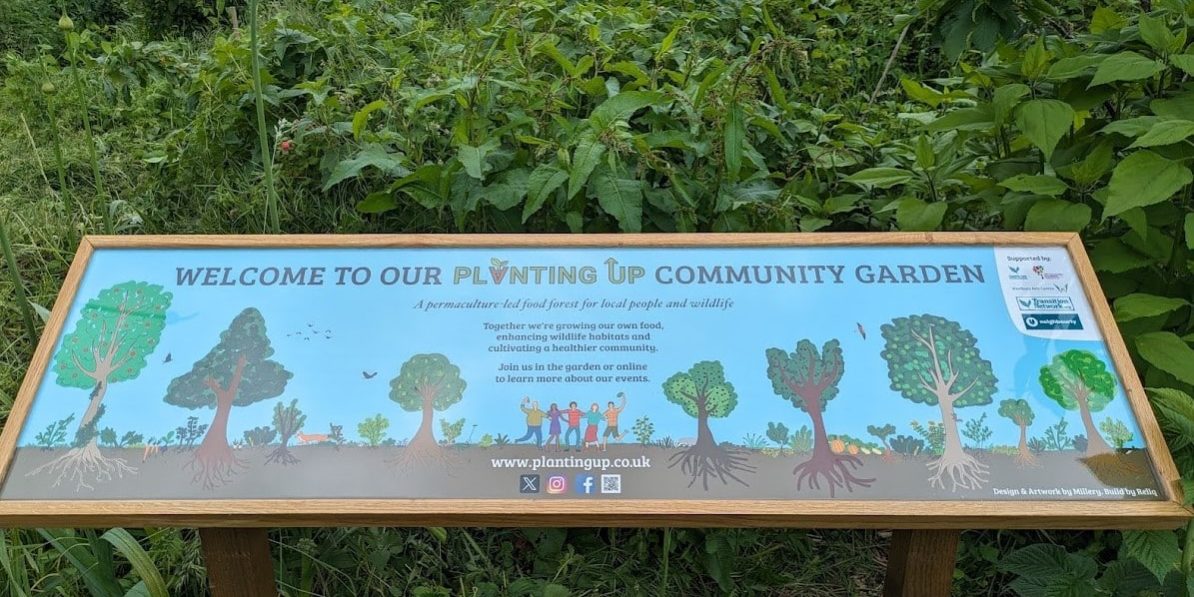 12 – Sign front on Our new community garden sign