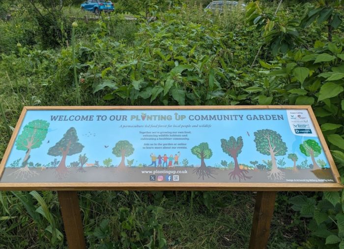 12 – Sign front on Our new community garden sign