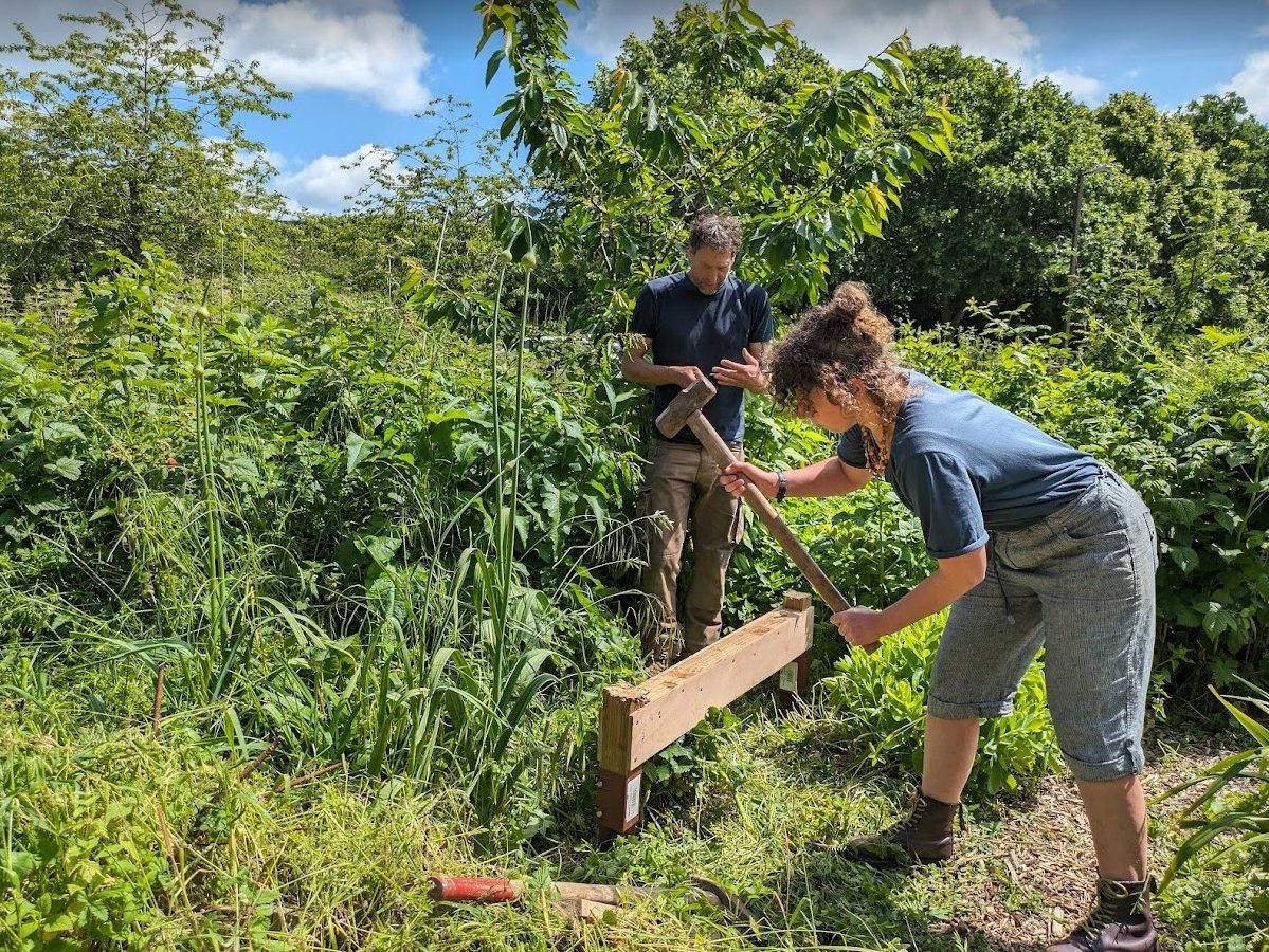 Hammering the foot spikes into the ground